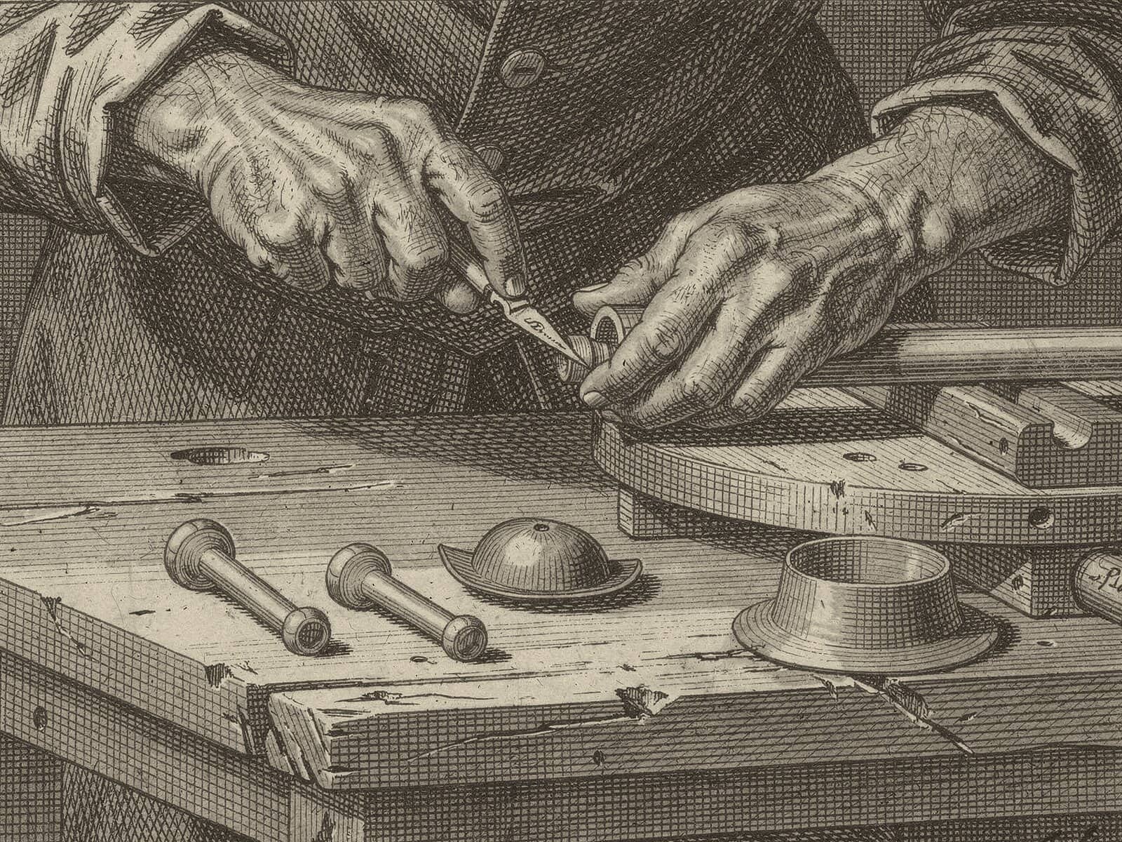 Engraving: hands carve small parts with a knife; turned arms, a hat brim and a hat crown lie ready on the bench.