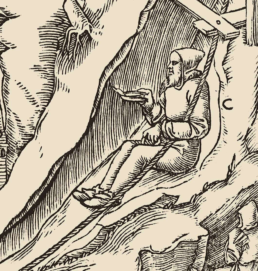 Detail of a woodcut from Agricola's De re metallica: a miner slides down an inclined shaft seated on his leather apron, holding a lamp.