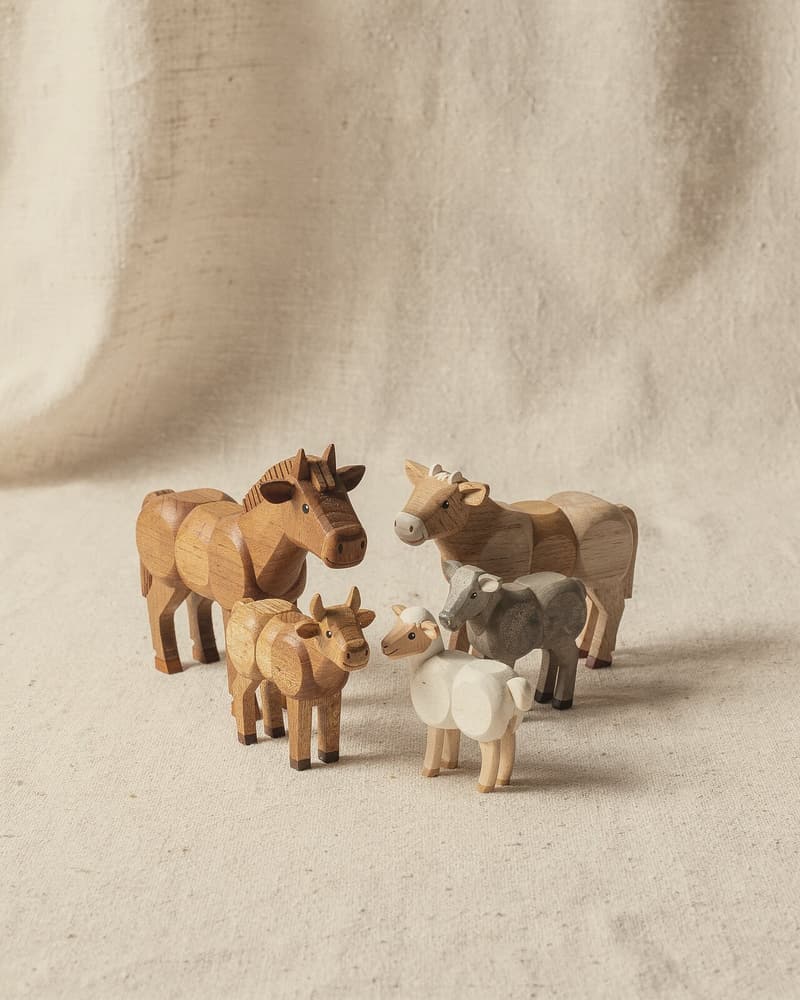 A small group of ring-turned animals: a horse, a cow, a calf, a sheep and a goat.